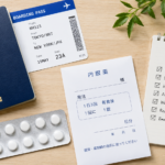 Passport, prescription paper, medicine package, and packing checklist for travel to Japan